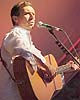 Zachary Richard playing guitar at the Festival Acadien
